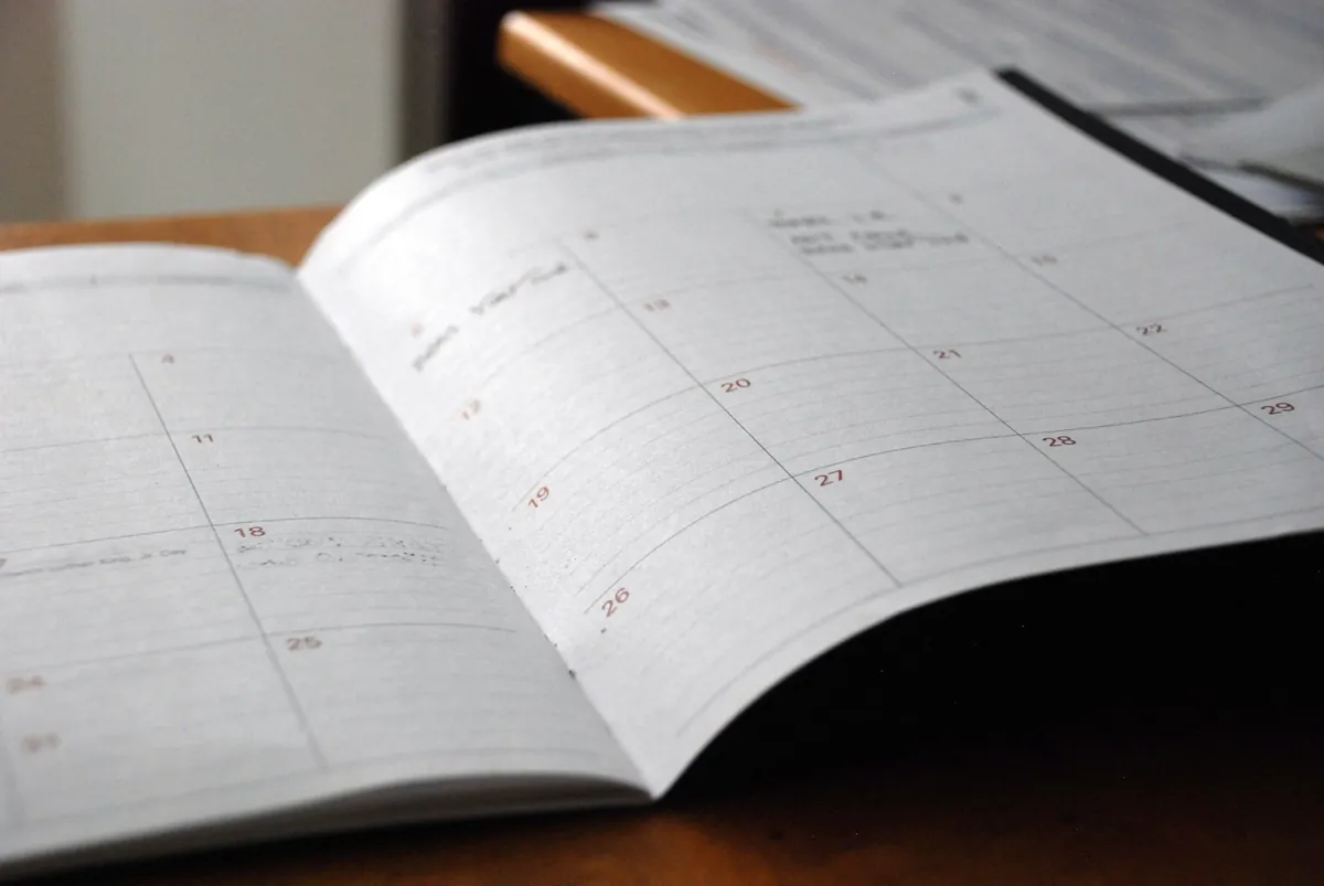 A blank monthly planner open on a table