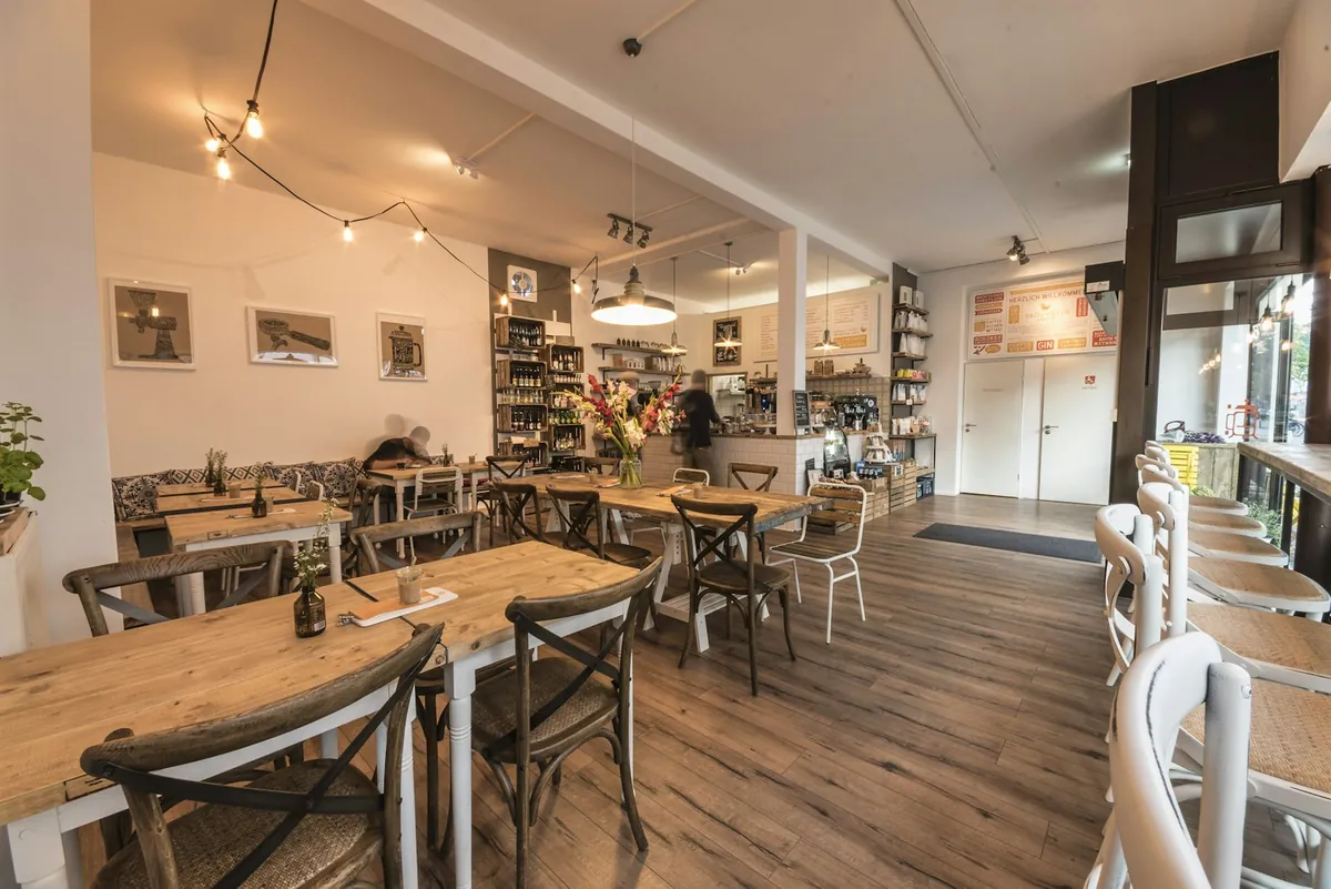 A bright cafe interior with wooden tables and chairs