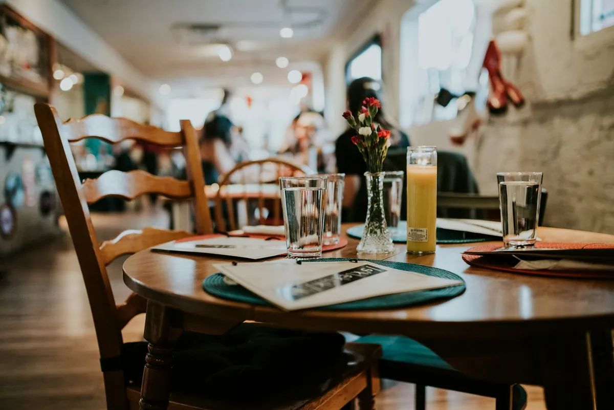 A cafe table set with a menu and drinks