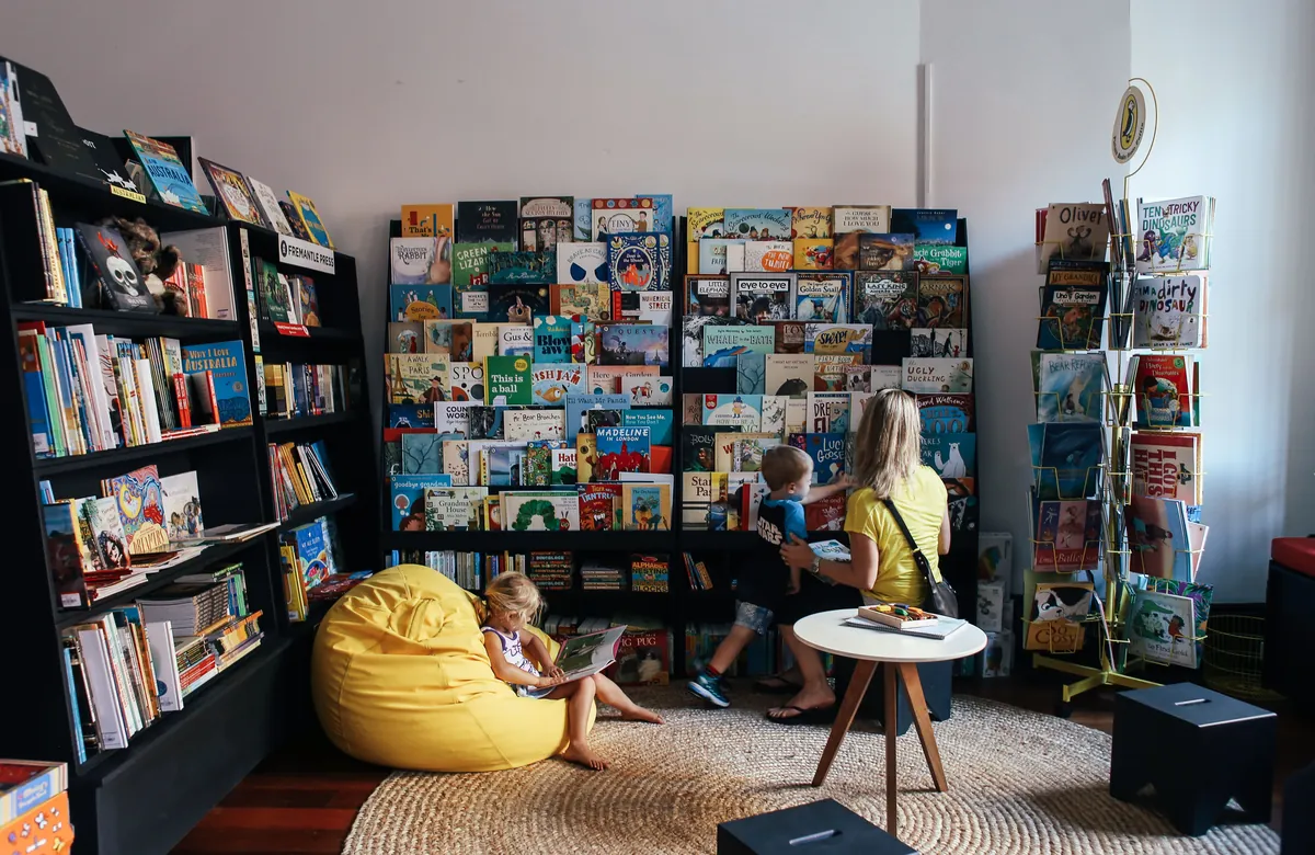 A childrens library area with low bookshelves and seating