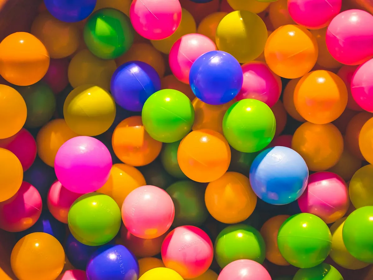 A close view of pink, blue and orange play balls