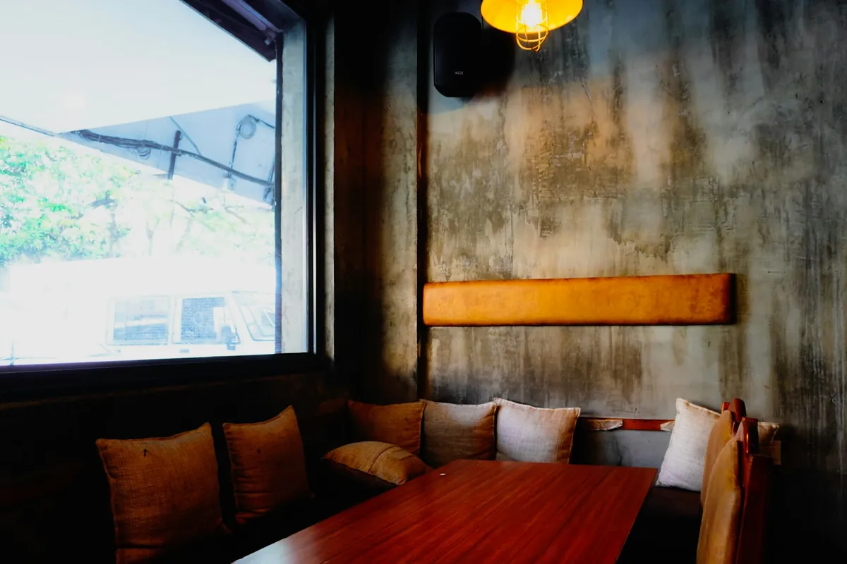 A corner bench seat with cushions in a quiet cafe