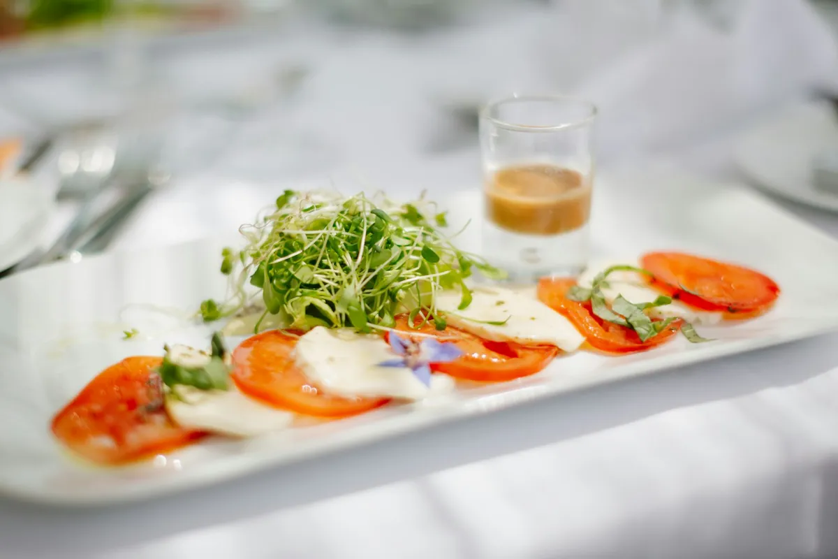 A plate of fresh salad with tomatoes and greens