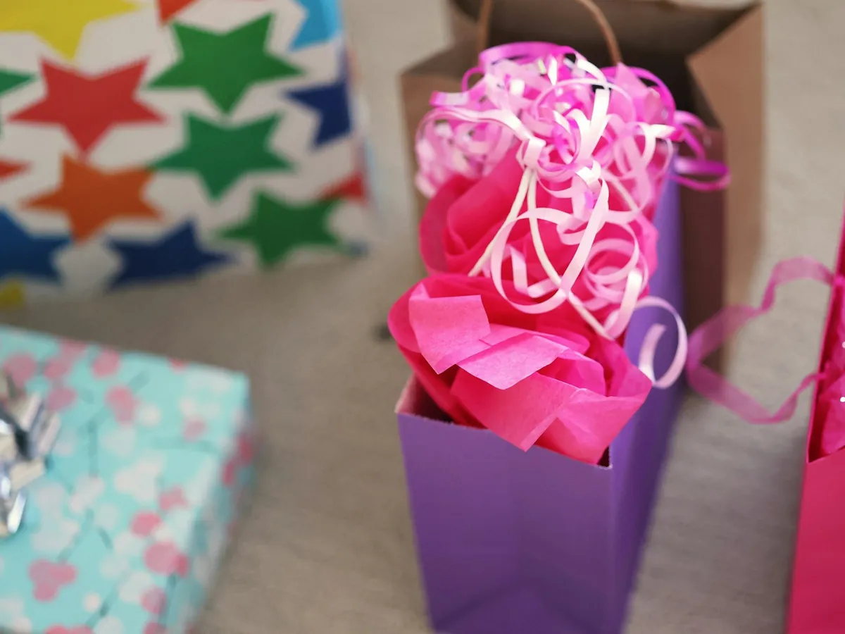 A small gift bag filled with pink tissue paper