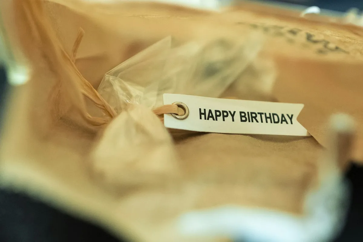 A wrapped gift with a happy birthday tag attached