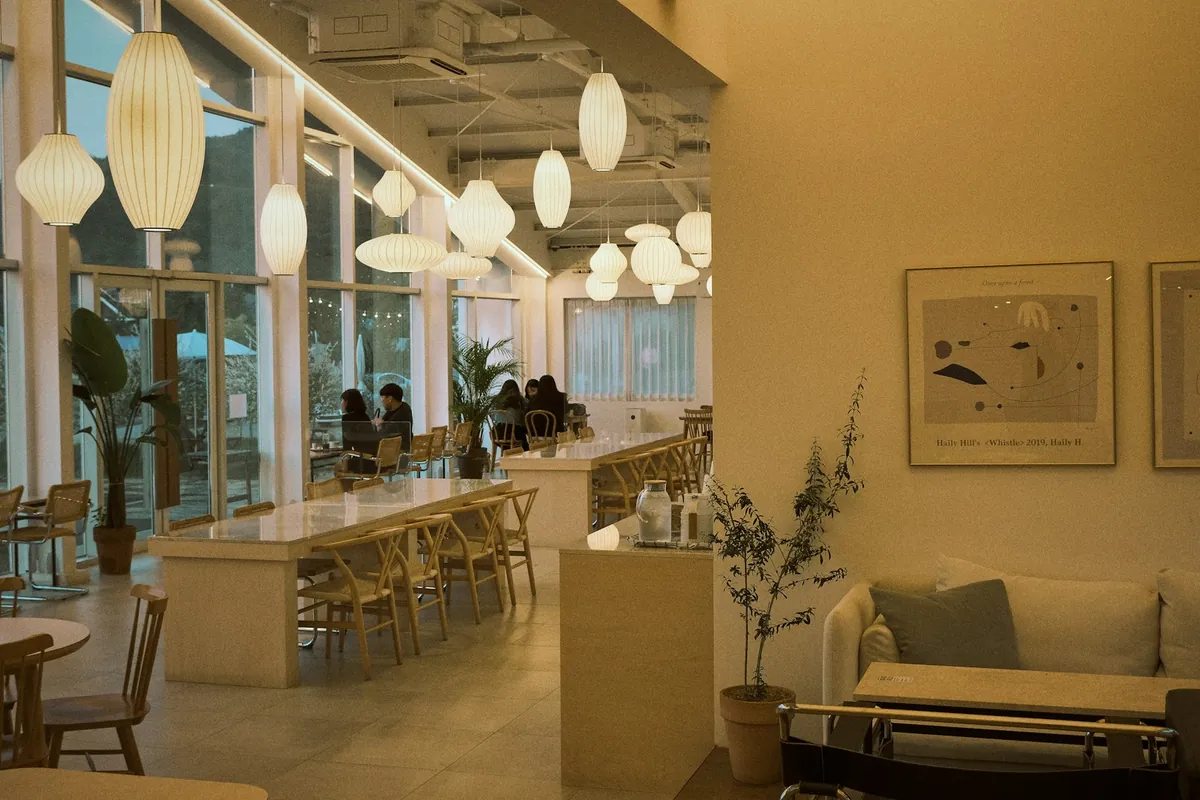 A light, open cafe counter with seating along the window