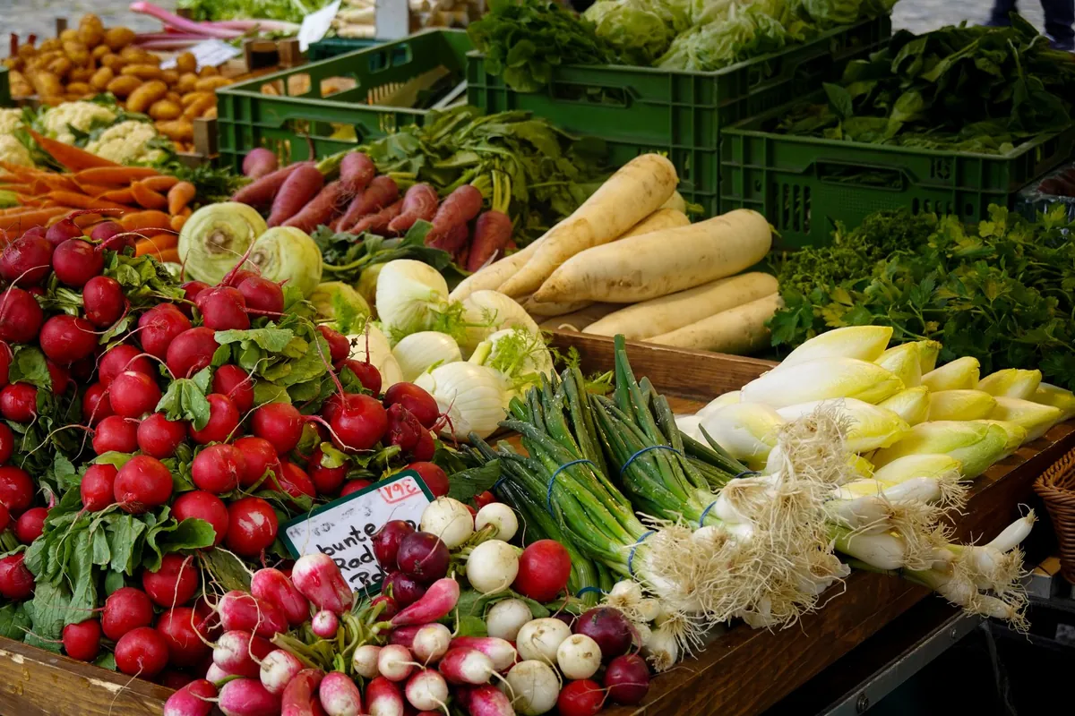 A farmers market stall stacked with fresh vegetables