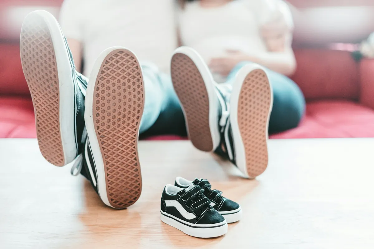 A pair of small canvas shoes on a floor