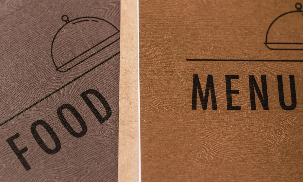 A printed food menu resting on a table