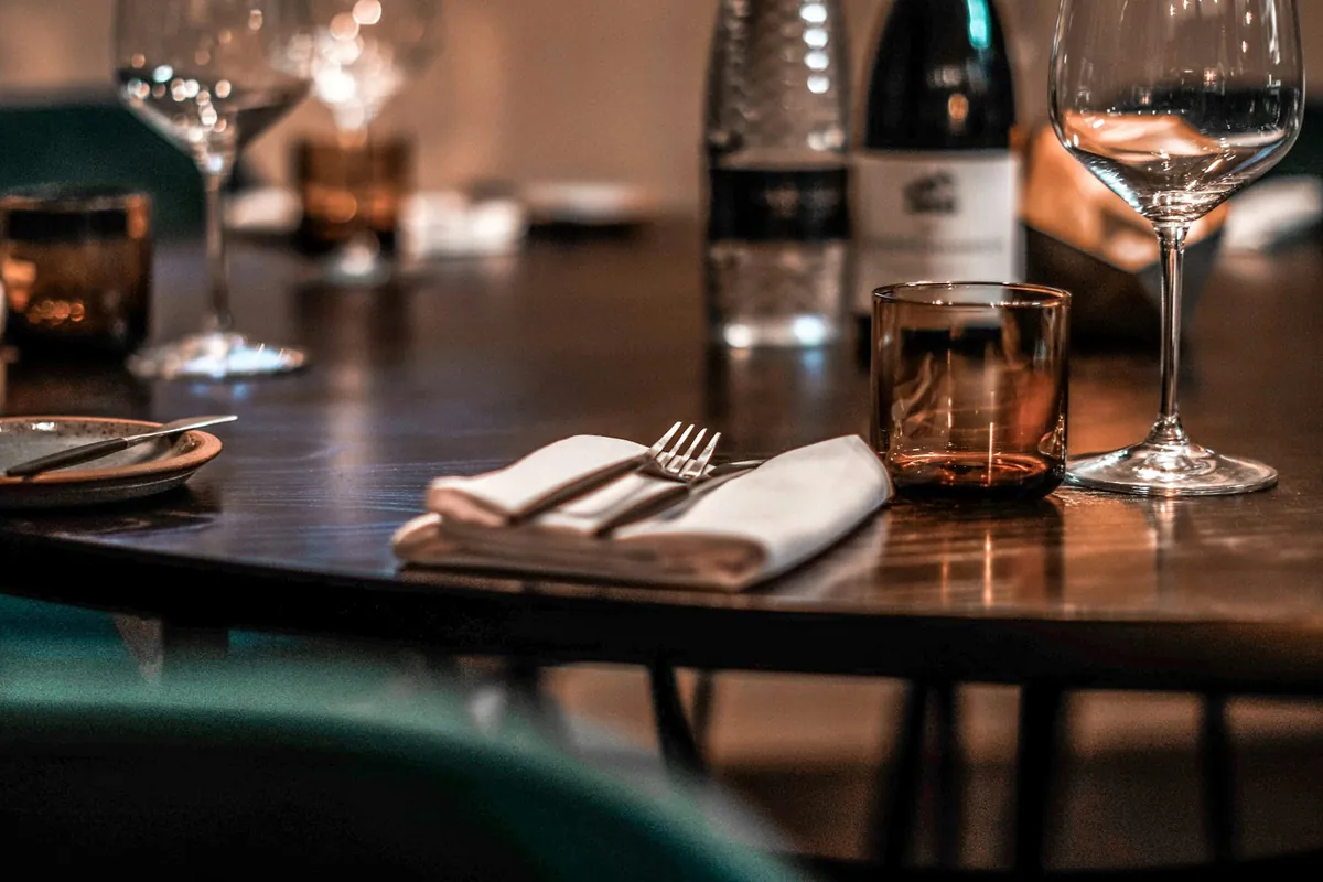 A table set with glasses and cutlery in a restaurant