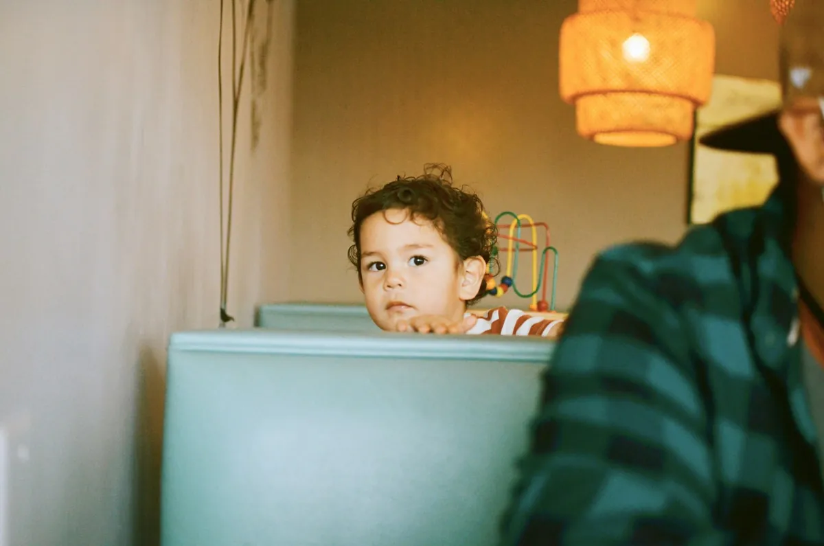 A small child held by an adult in a cafe