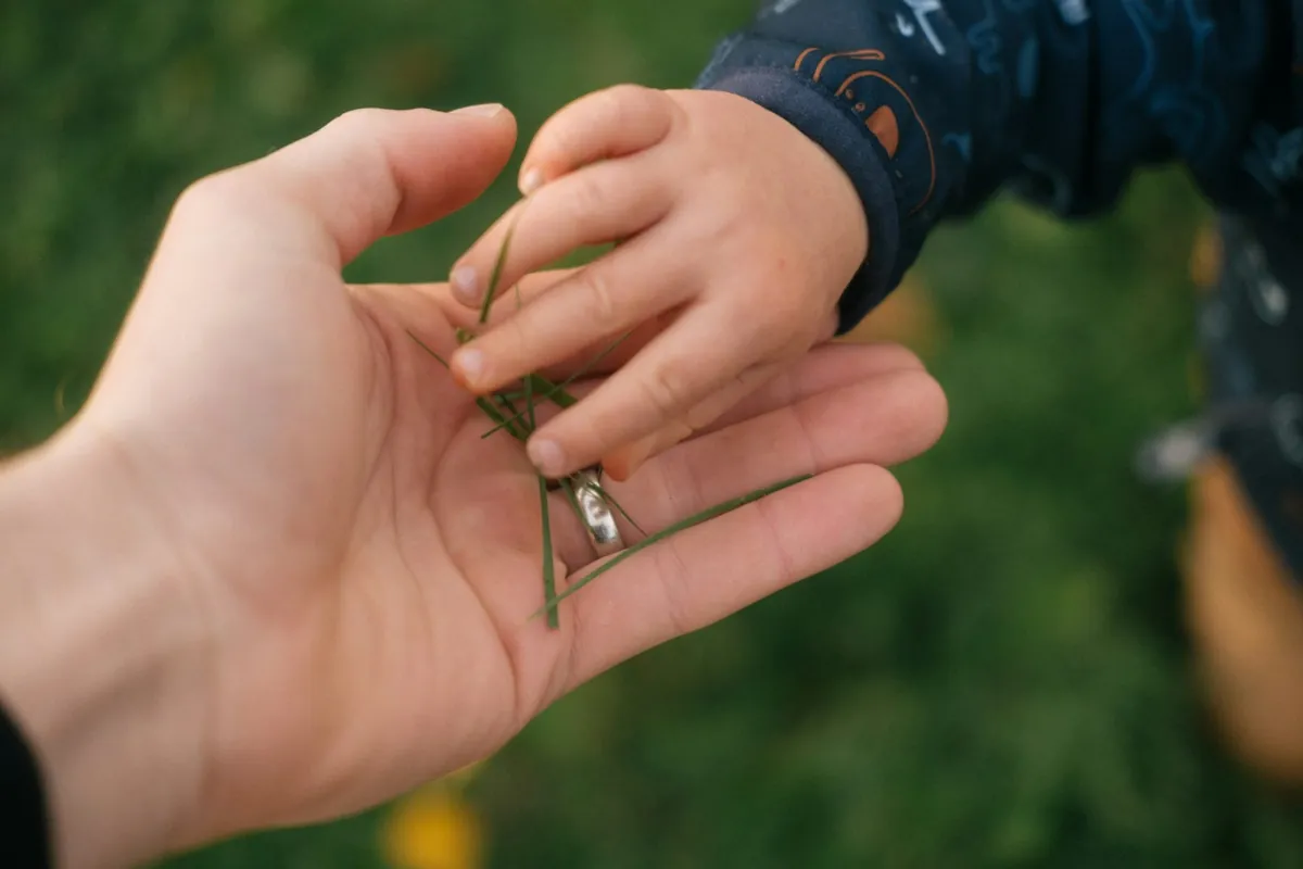 A small child hand resting in an adult hand
