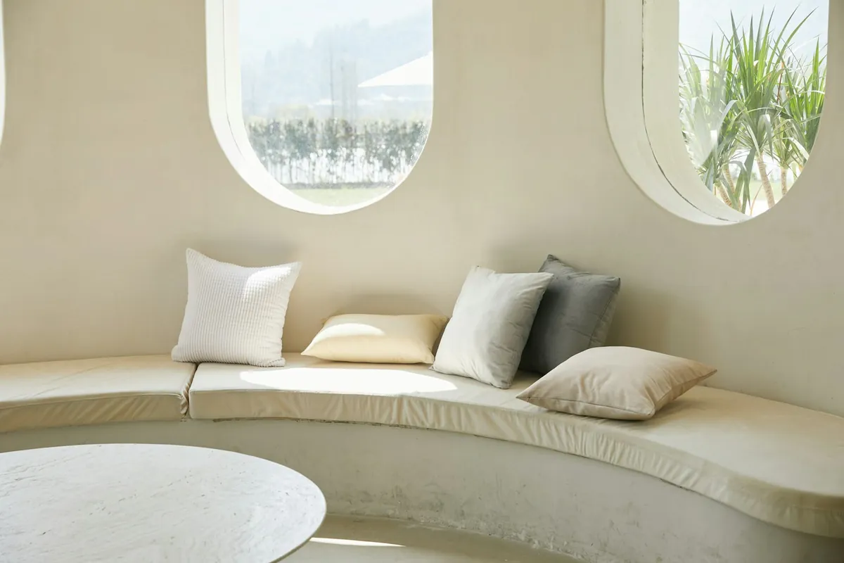 A soft window seat with neutral cushions