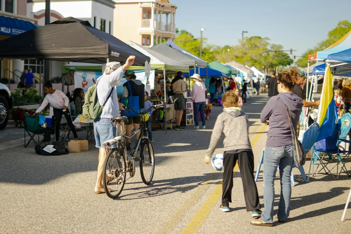 A street market with stalls and people walking