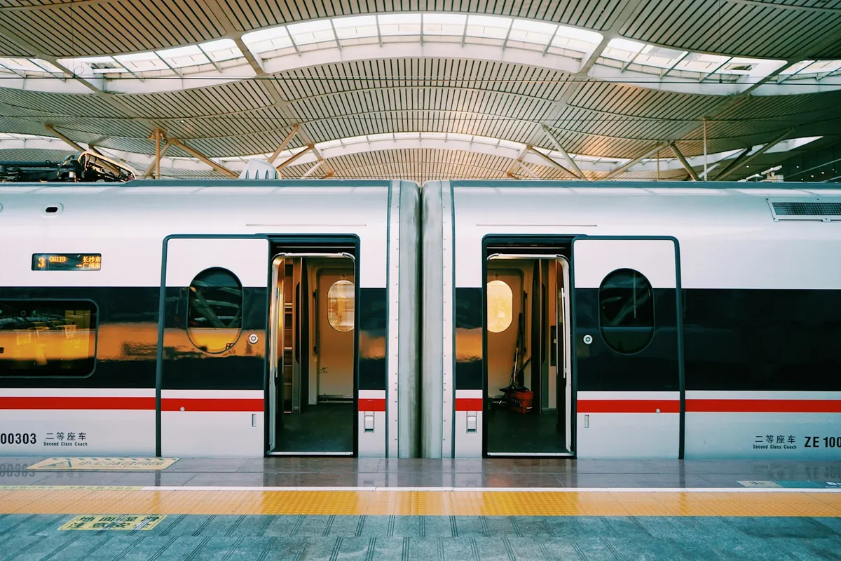 A light rail train with open doors at a platform