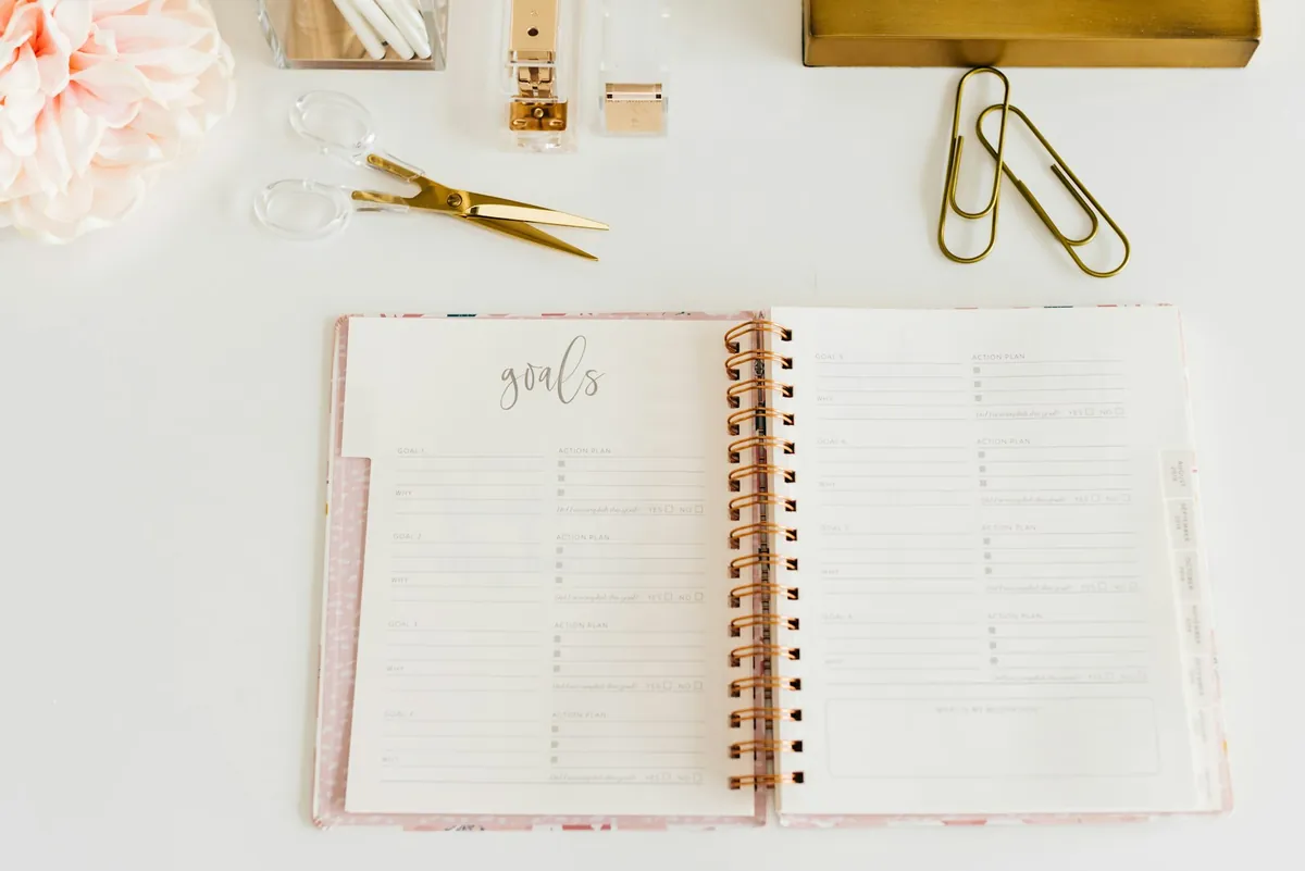 An open notebook and pen laid out for planning