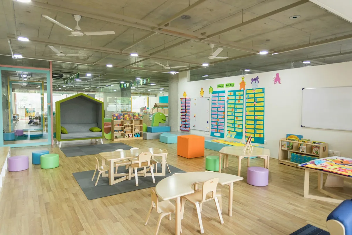 An open play room with low tables and storage baskets