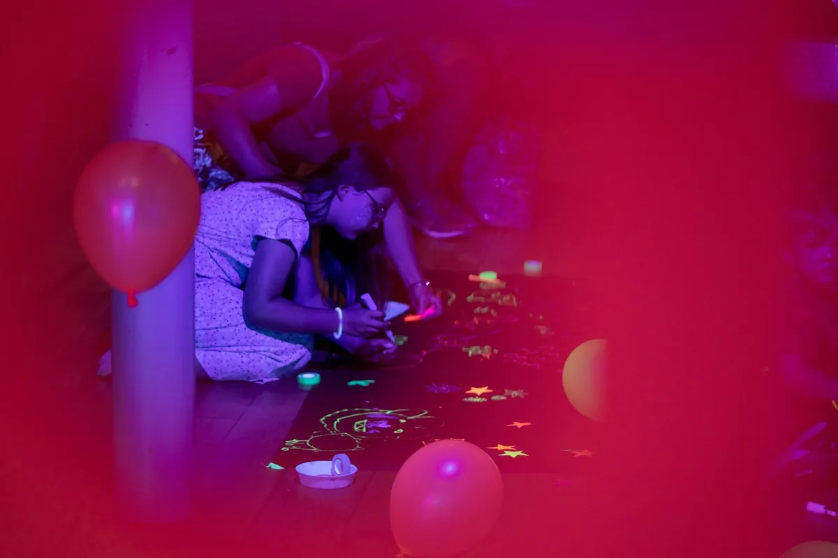 Balloons and confetti scattered across a floor