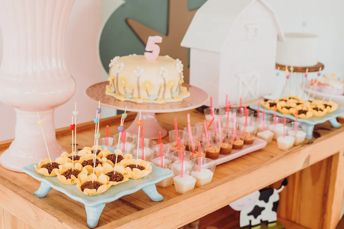 A birthday cake and desserts arranged on a table