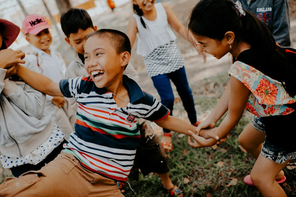 Children holding hands and playing together in a circle