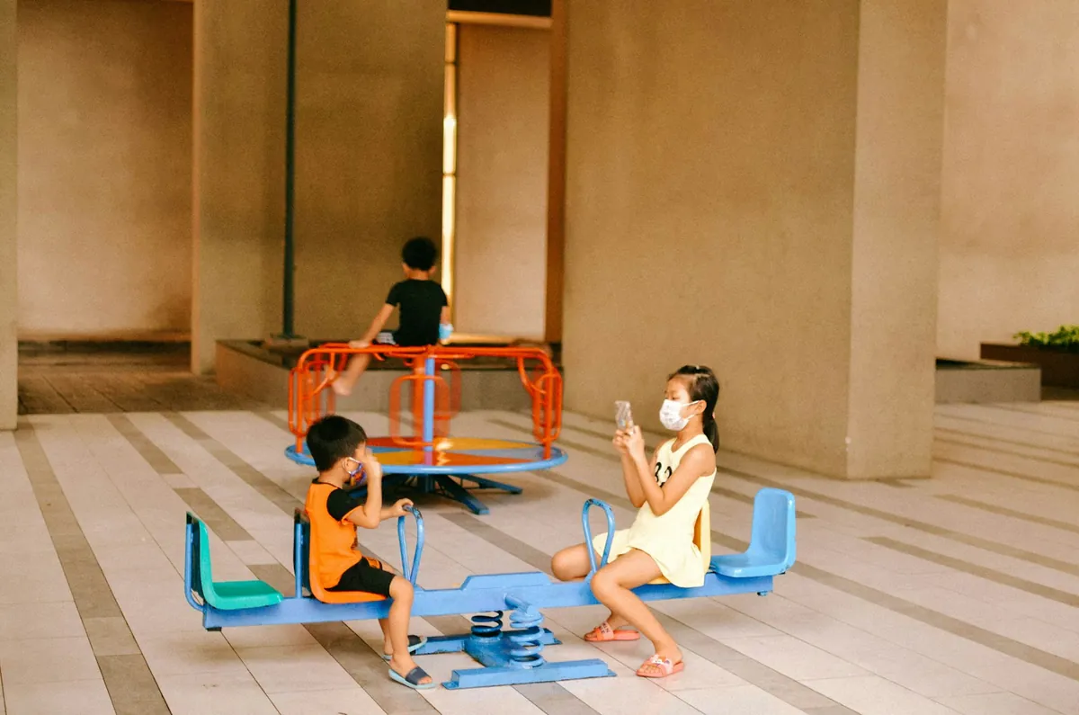 Children playing with ride-on toys on an indoor floor