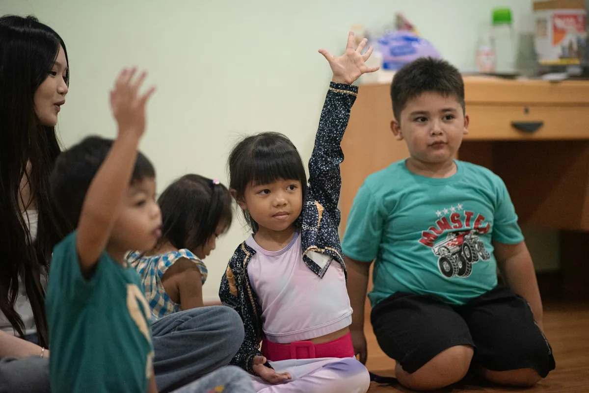 Children sitting on the floor together in a group