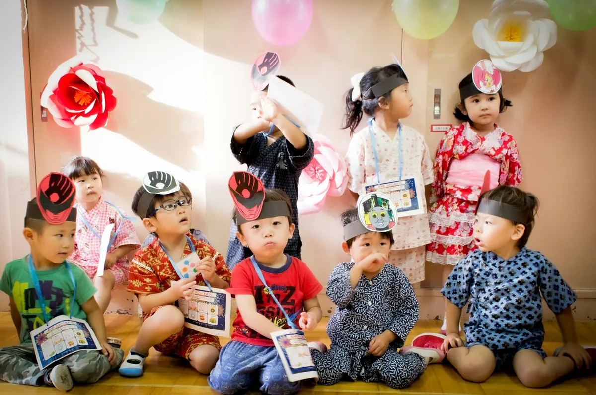 A group of young children sitting together at a party