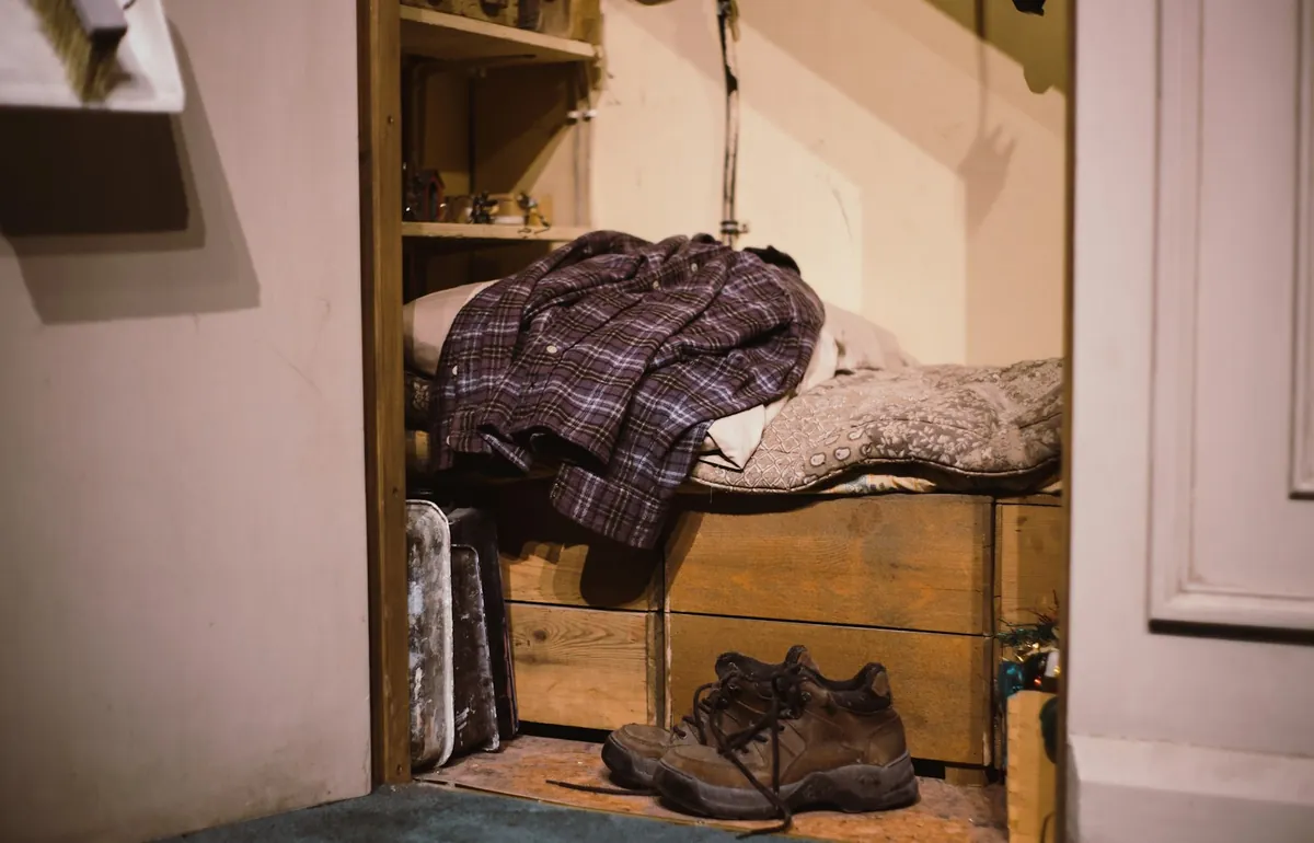 Coats folded and boots left in a hallway
