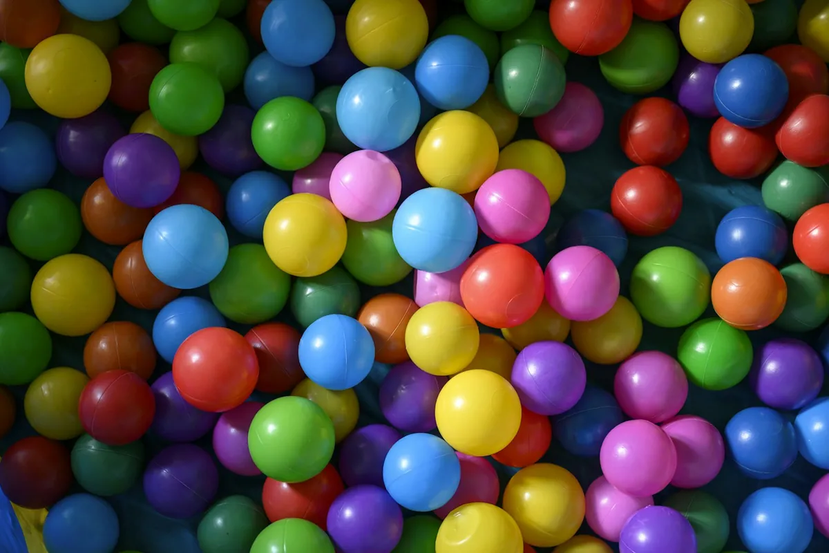 Brightly coloured plastic balls filling a ball pit