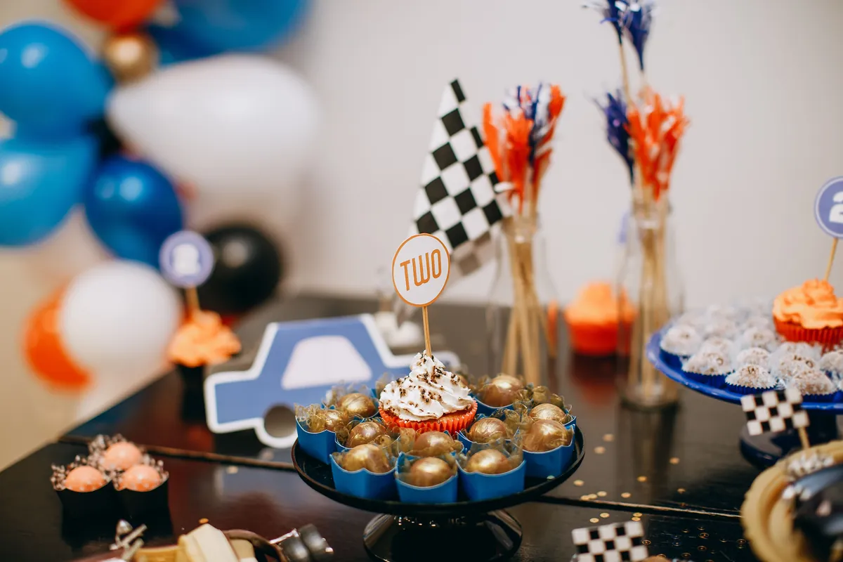 Cupcakes and balloons arranged on a party table