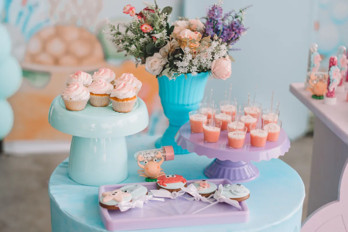 Cupcakes arranged on a cake stand with flowers