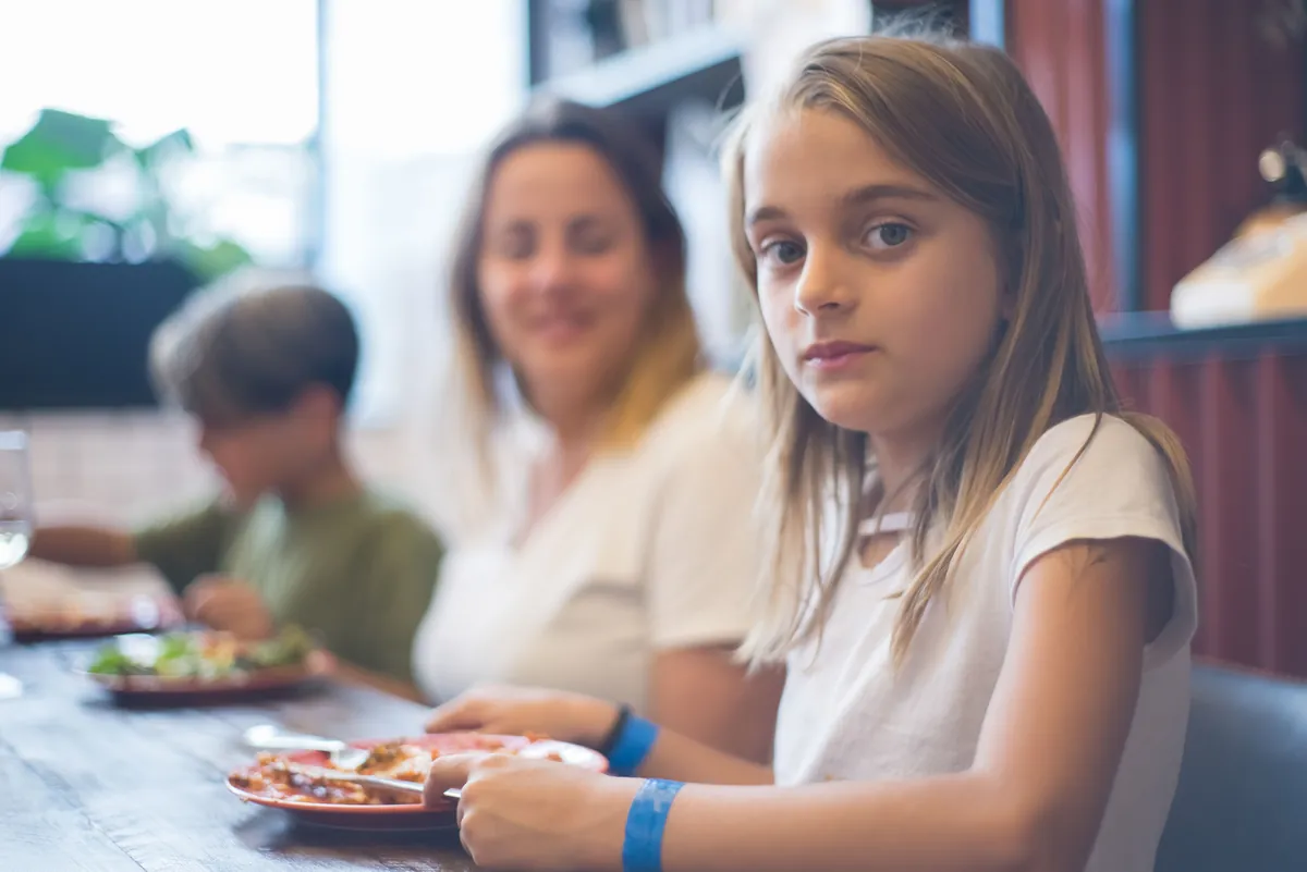 A family with two children sitting together at a cafe table
