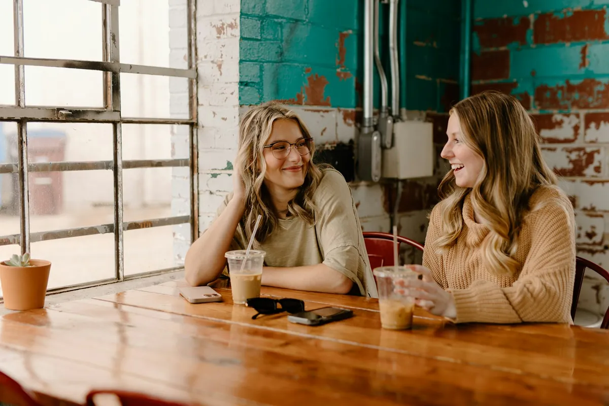 Friends sitting and talking at a cafe table