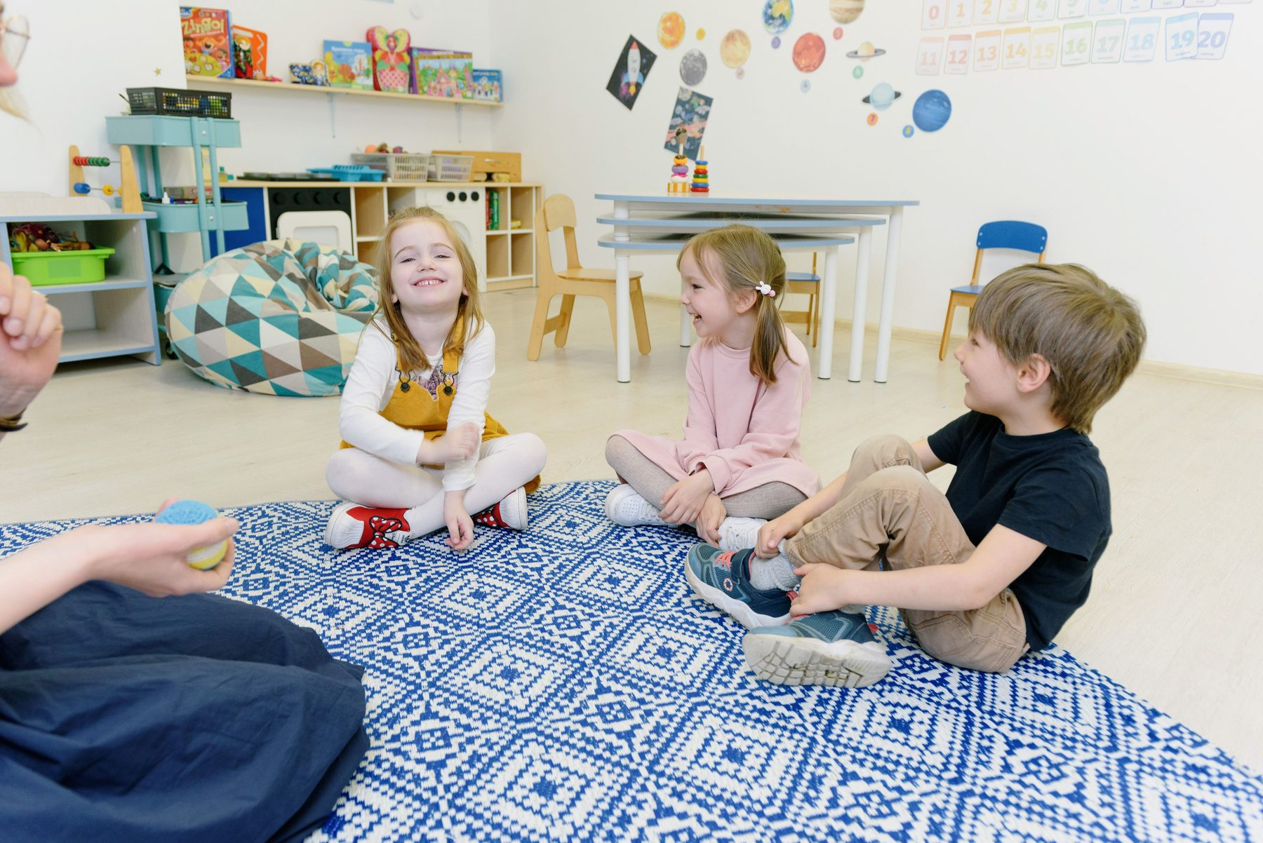 Children playing together in a bright, toy-filled indoor playroom