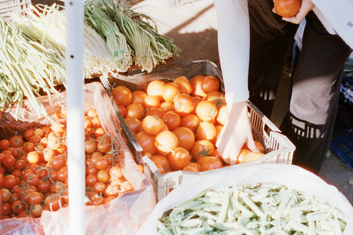 Onions and green beans displayed on a market stall