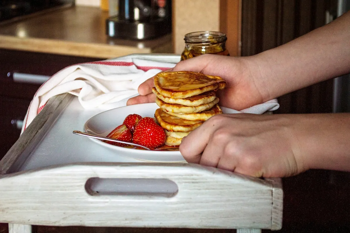 A plate of pancakes served with fresh fruit