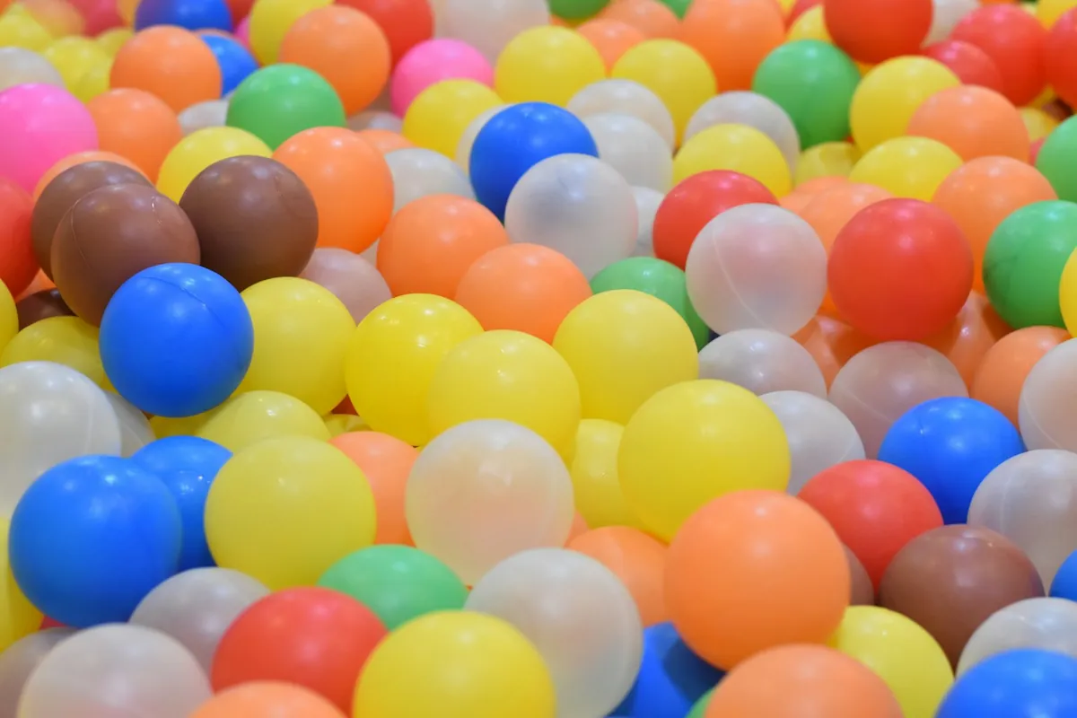Pastel coloured play balls filling a soft play pit
