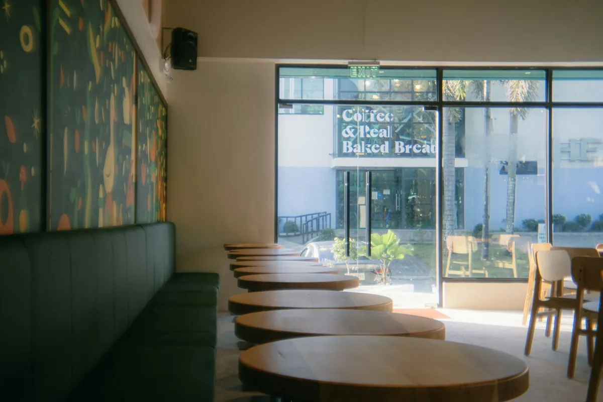 Round cafe tables set along a padded bench seat