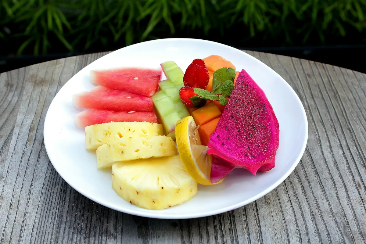 Sliced watermelon, pineapple and dragon fruit on a plate
