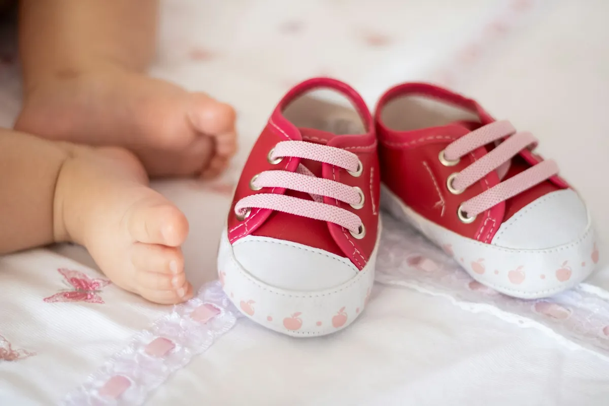 A pair of small red canvas shoes