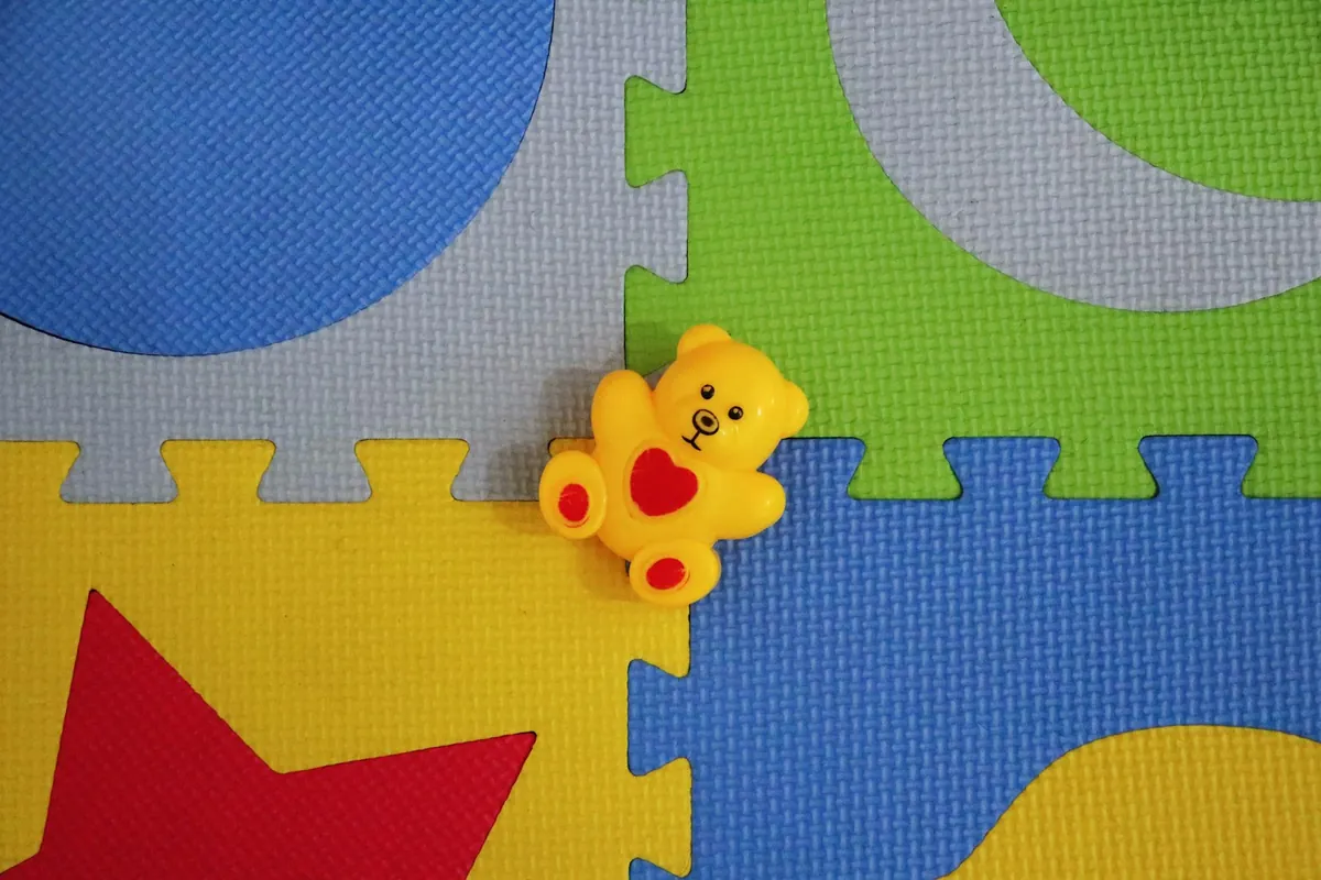 Brightly coloured soft foam play mat tiles on a floor