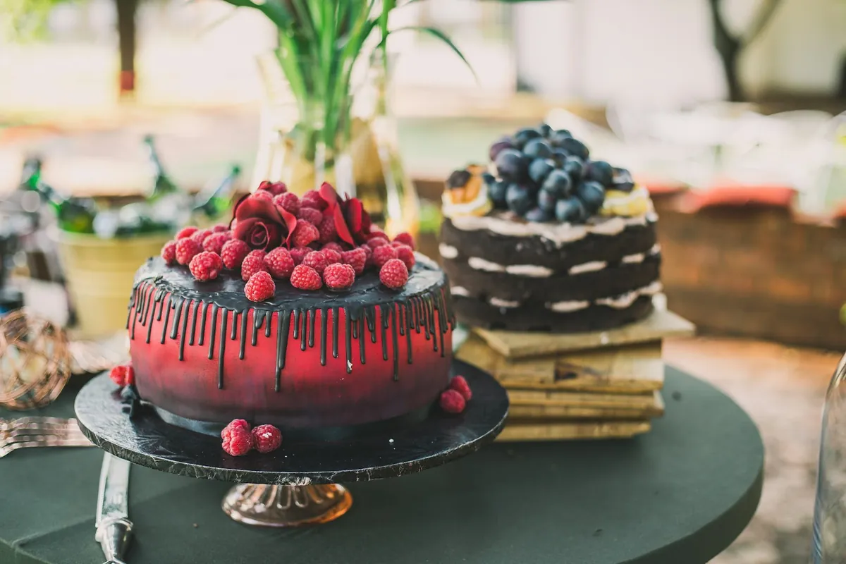 Two decorated birthday cakes standing side by side