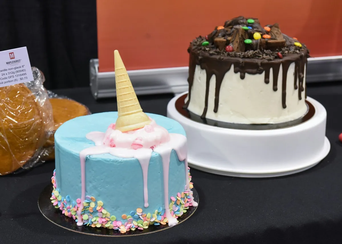 Two very different birthday cakes on a party table