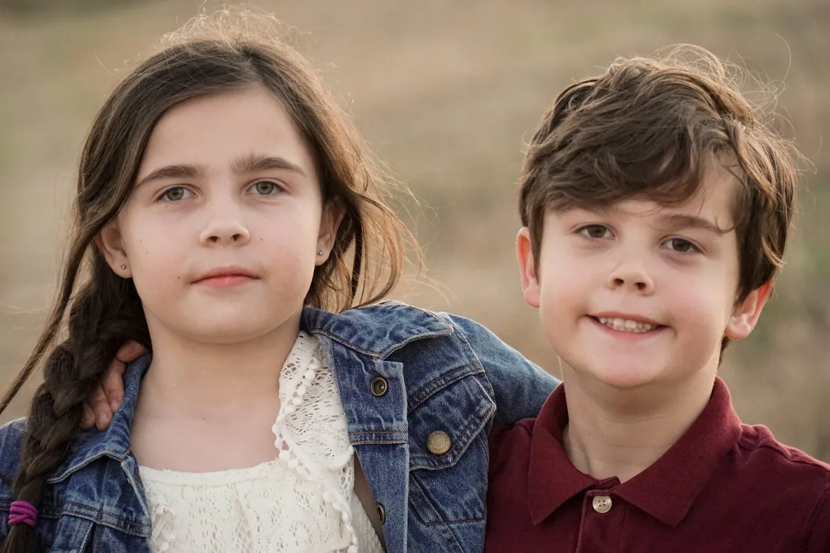 Two children standing side by side smiling