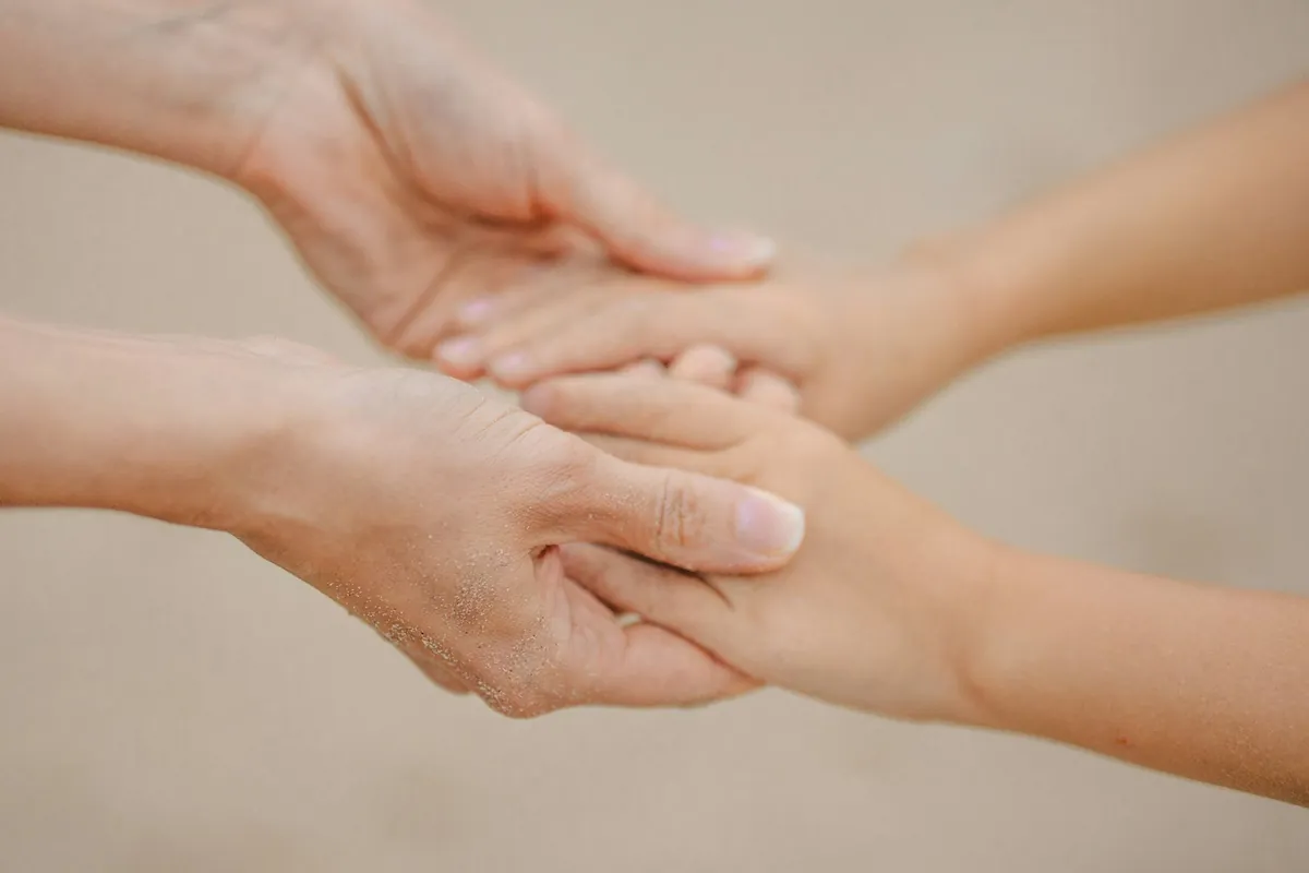 A small hand resting in a larger one