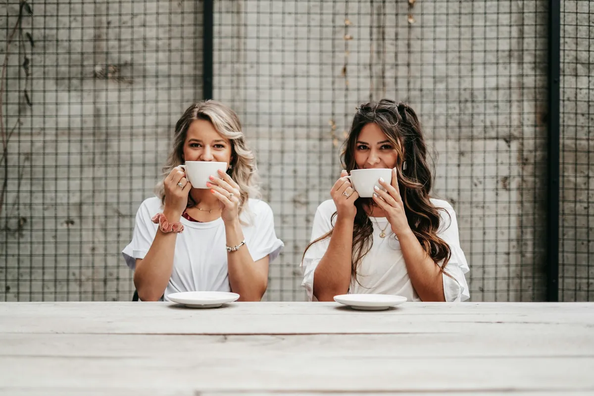 Two people drinking coffee together at a counter