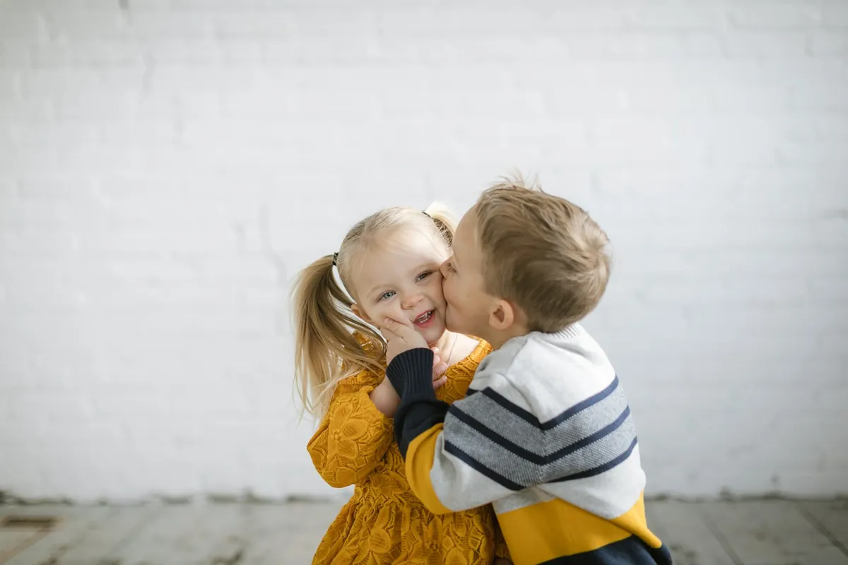 Two small children hugging each other