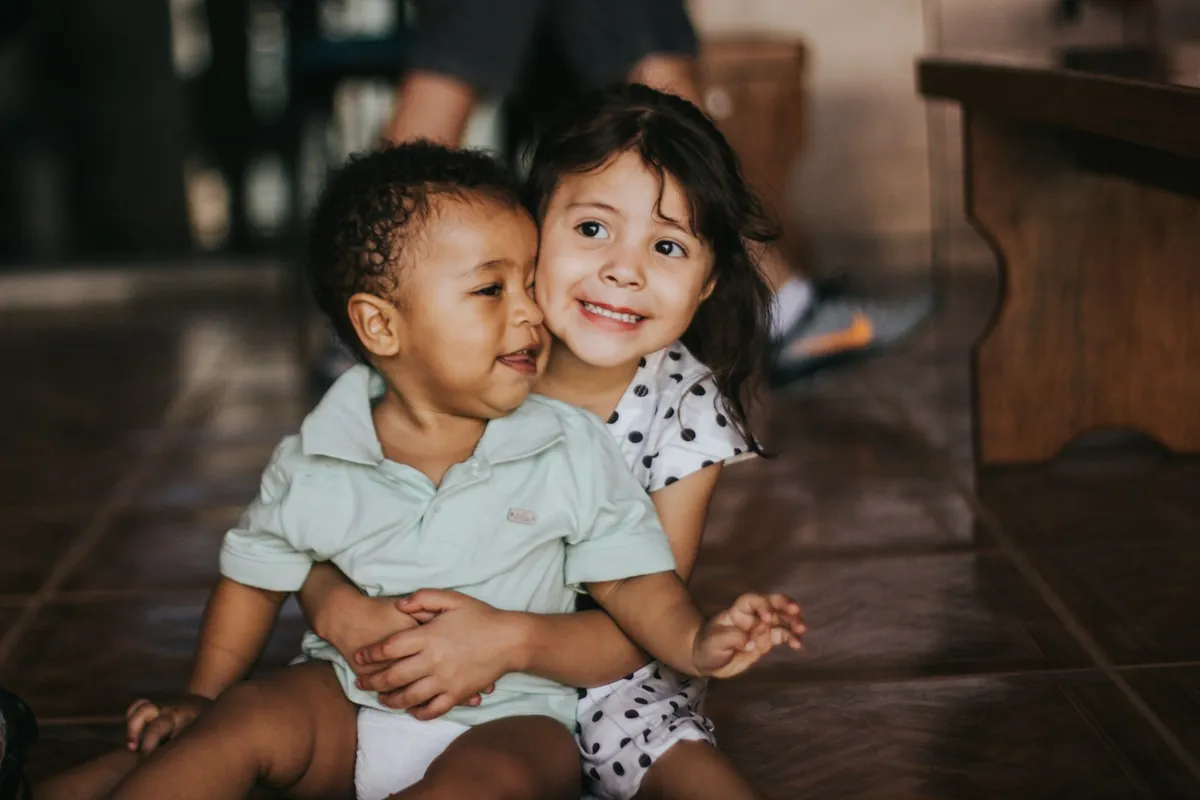 Two young children sitting side by side