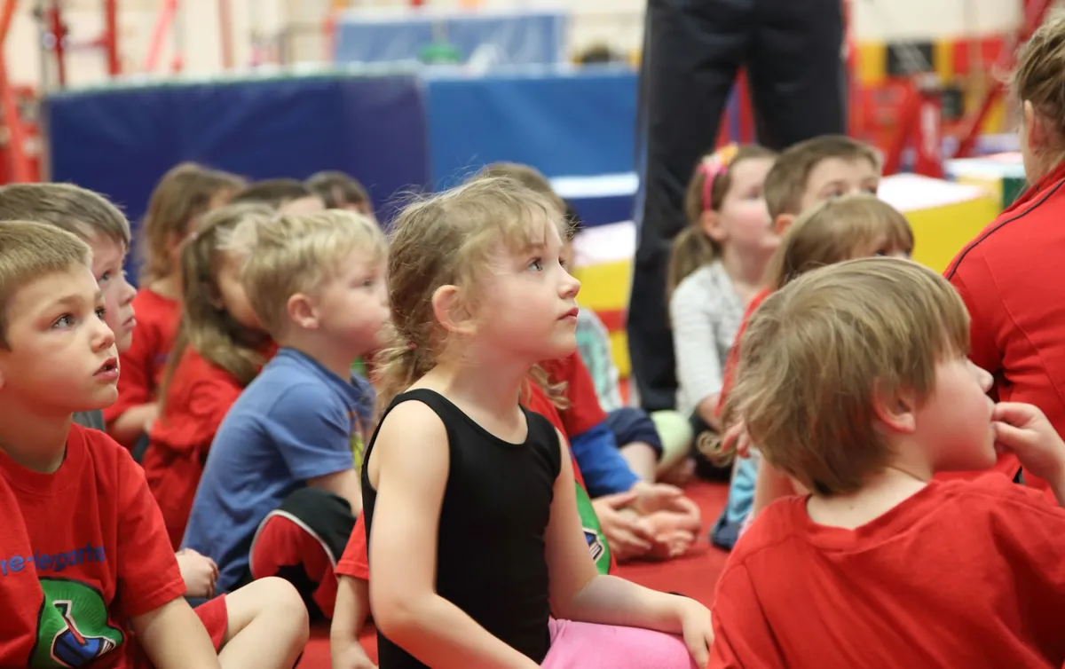 Young children sitting together listening to a story